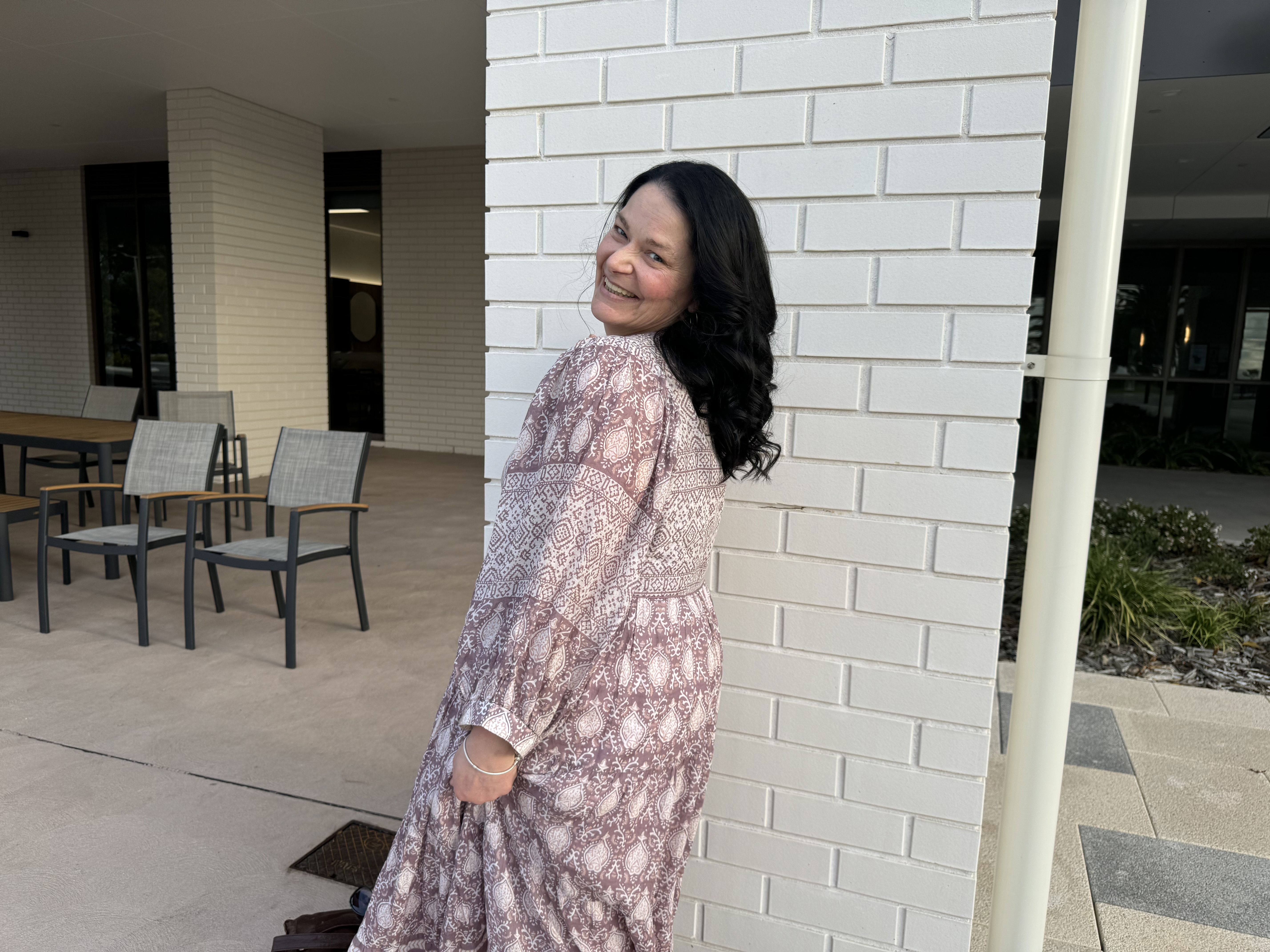 Brightwater Oats Street client after her hair makeover at salon in Inglewood in front of white wall out front