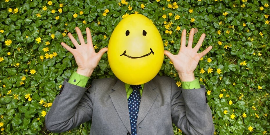 Man in suit with yellow smiling face