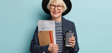 shot-happy-senior-experienced-businesswoman-holds-papers-pocketbooks-drinks-takeaway-coffee-glad-sign-successful-contract-wears-stylish-hat-coat-poses-indoor-busy-old-worker.jpg