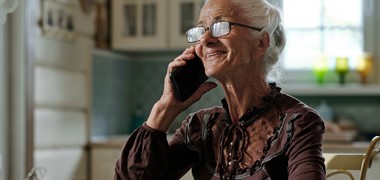 cheerful-senior-woman-eyeglasses-smart-blouse-talking-mobile-phone.jpg