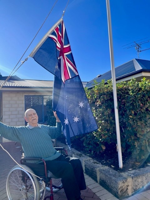 Brightwater resident John East with the Australian flag