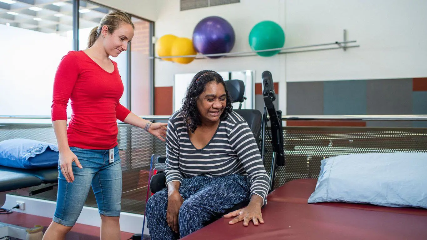 Brightwater Physiotherapy Services_physiotherapy staff member with disability client helping in the gym