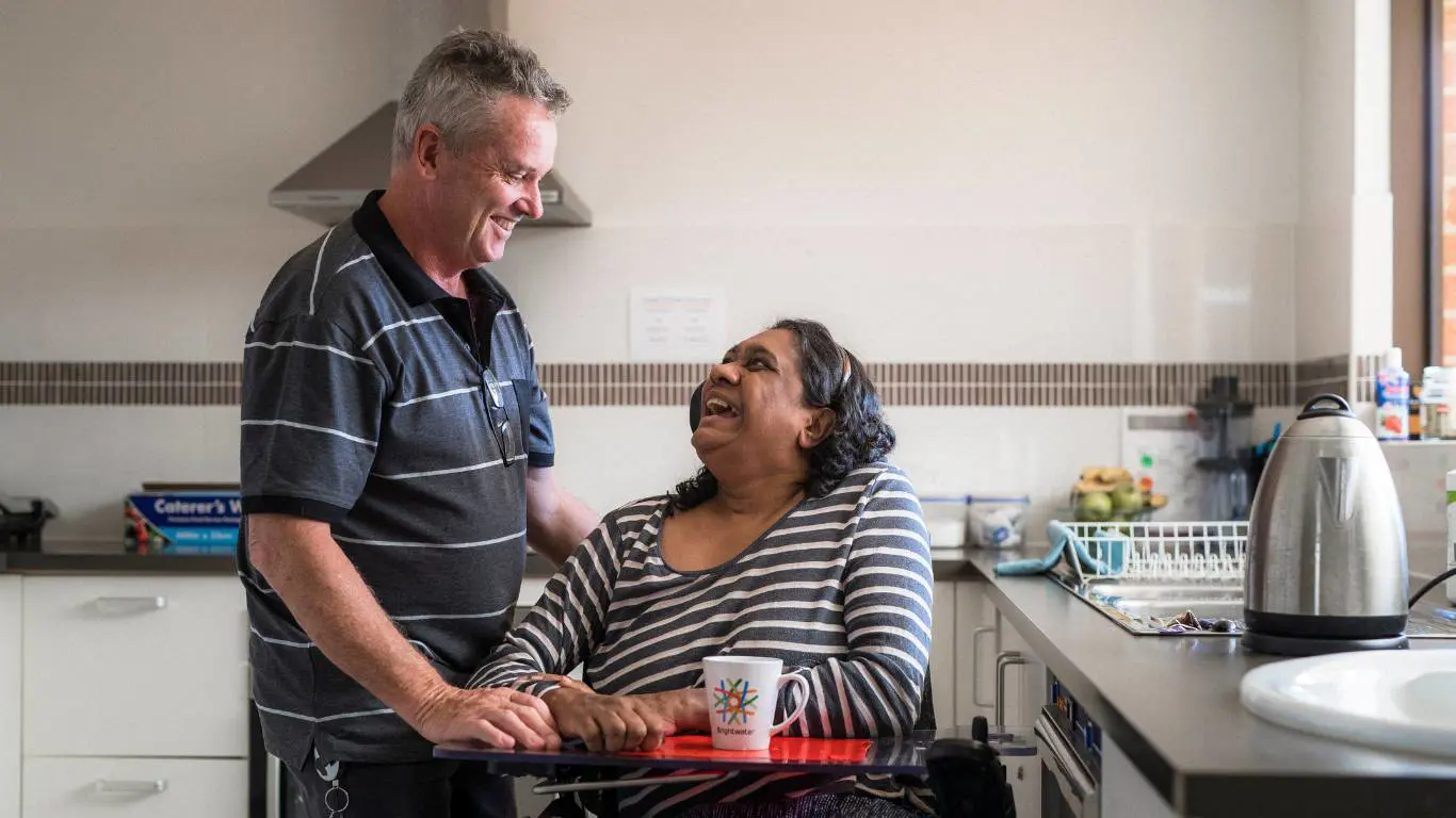 Brightwater Oats Street_disability client with staff having a laugh in the kitchen