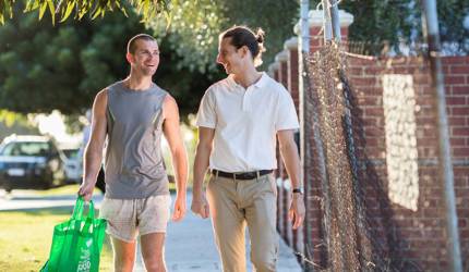 Brightwater Oats Street_disability client walking home with friend and groceries in hand