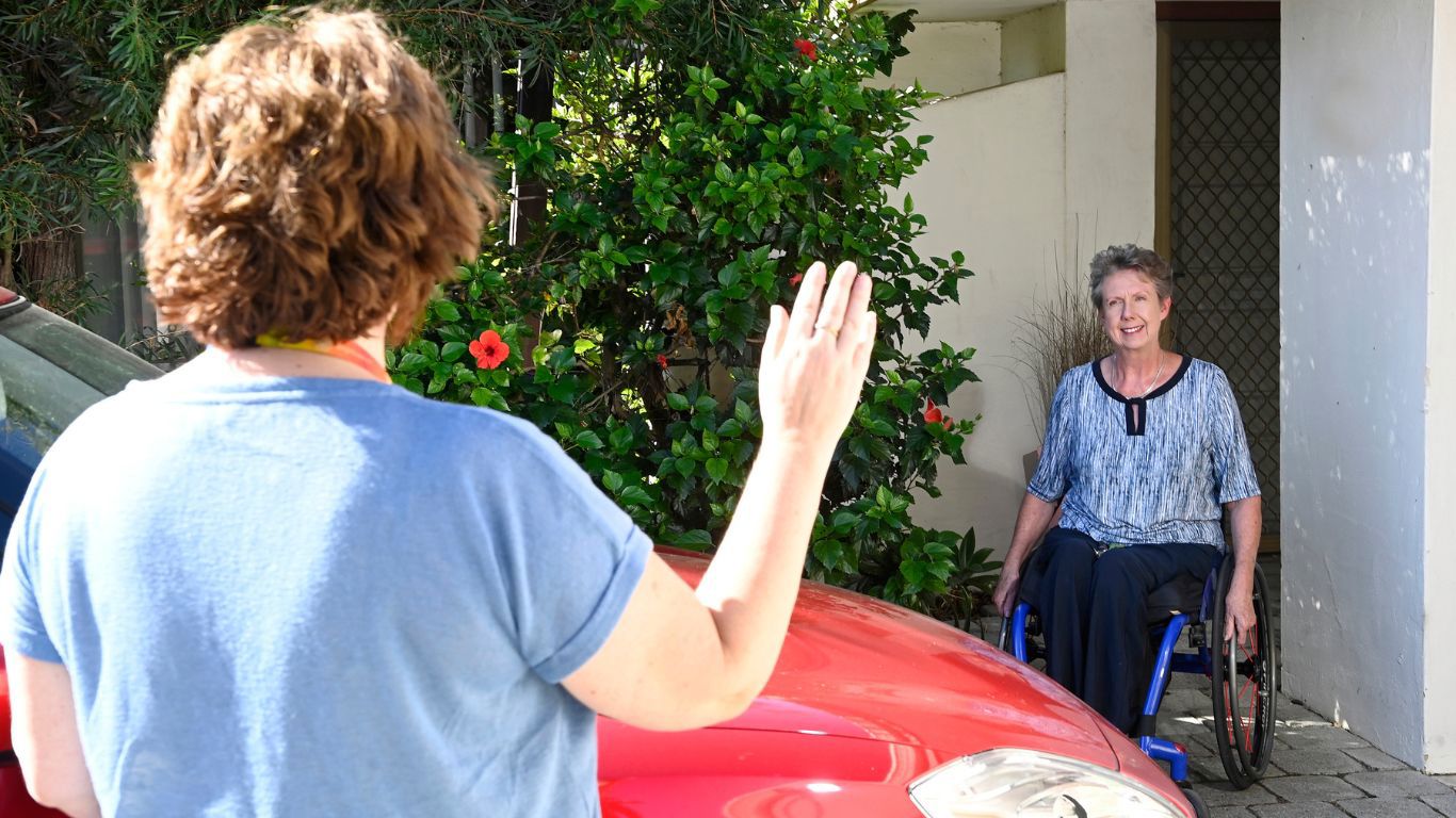 Occupational Therapy Driving Assessment_instructor waving goodbye to disability client in wheelchair after completing driving assessment test