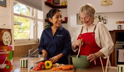 Support at Home Services Explained | Your 2025 Guide to What’s Included_Australian home care with care worker in kitchen helping cook with client