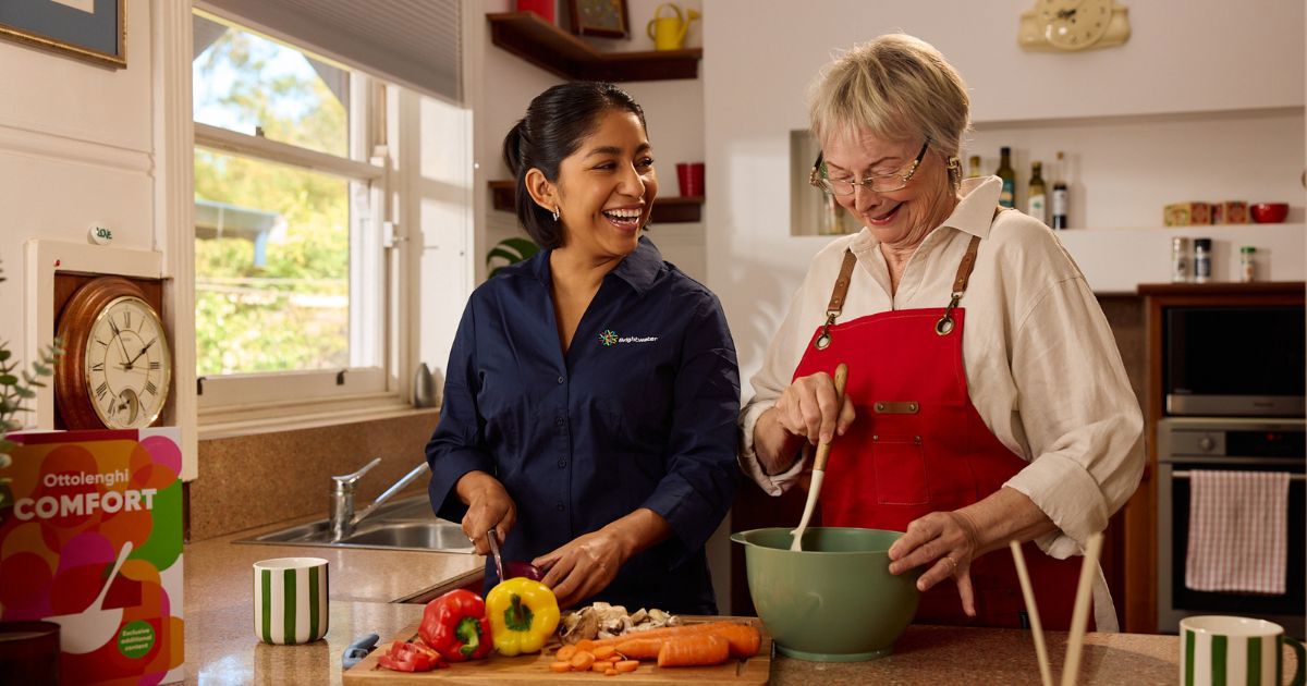 Support at Home Services Explained | Your 2025 Guide to What’s Included_Australian home care with care worker in kitchen helping cook with client
