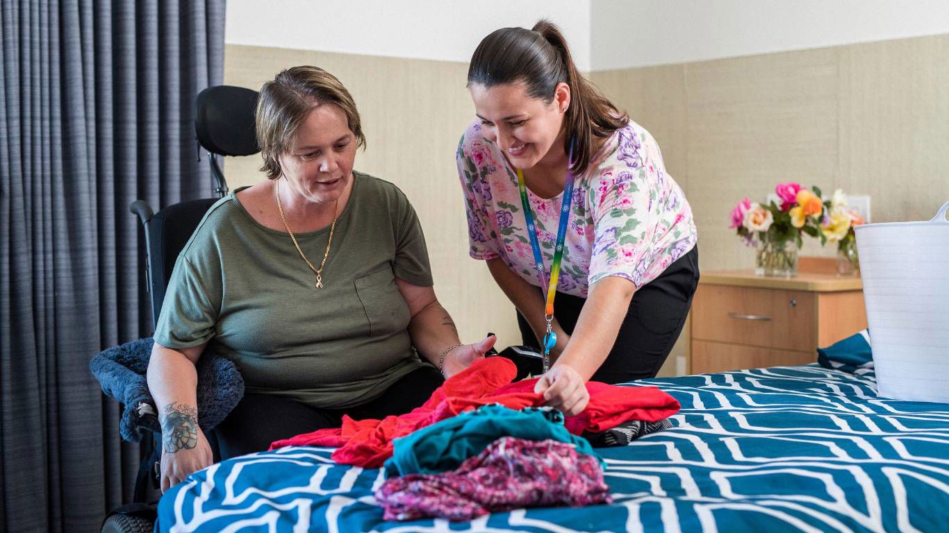 Brightwater Oats Street_disability client picking out what clothes to wear for the day with staff member helping choose