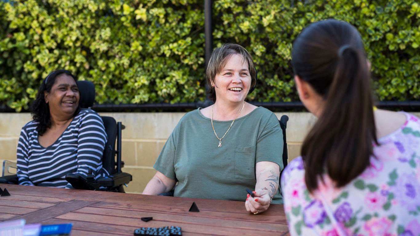 Brightwater Oats Street_disability clients enjoying time with friends and staff outside playing games
