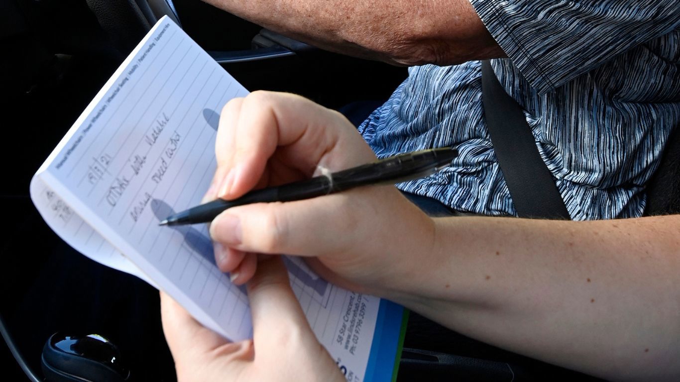 Occupational Therapy Driving Assessment_closeup shot of instructor making notes on driving test