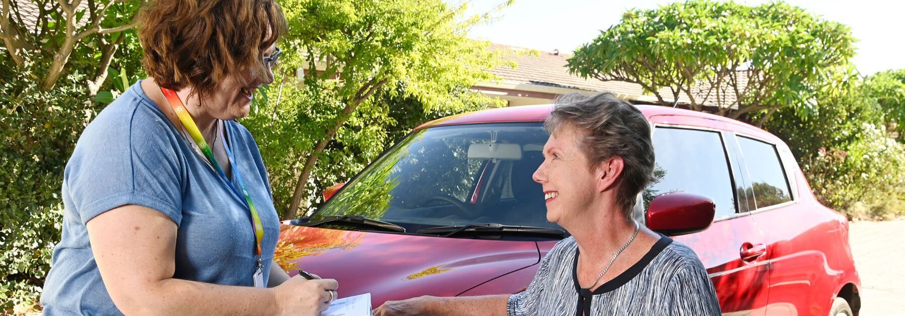 Occupational Therapy Driving Assessment header_driving instructor giving disability patient good news that she passed her practical driving test